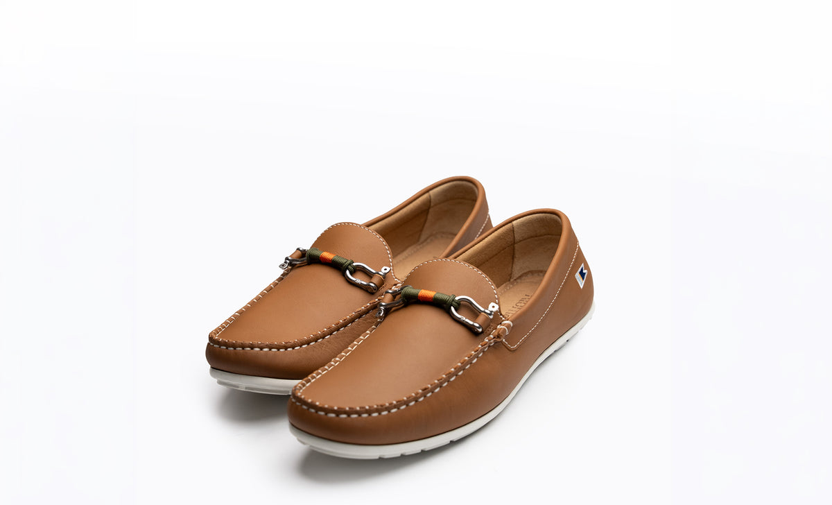 The Newport Waterman, a tan leather driving moccasin, with the hand-tied Duck Blind bearing in olive green and orange