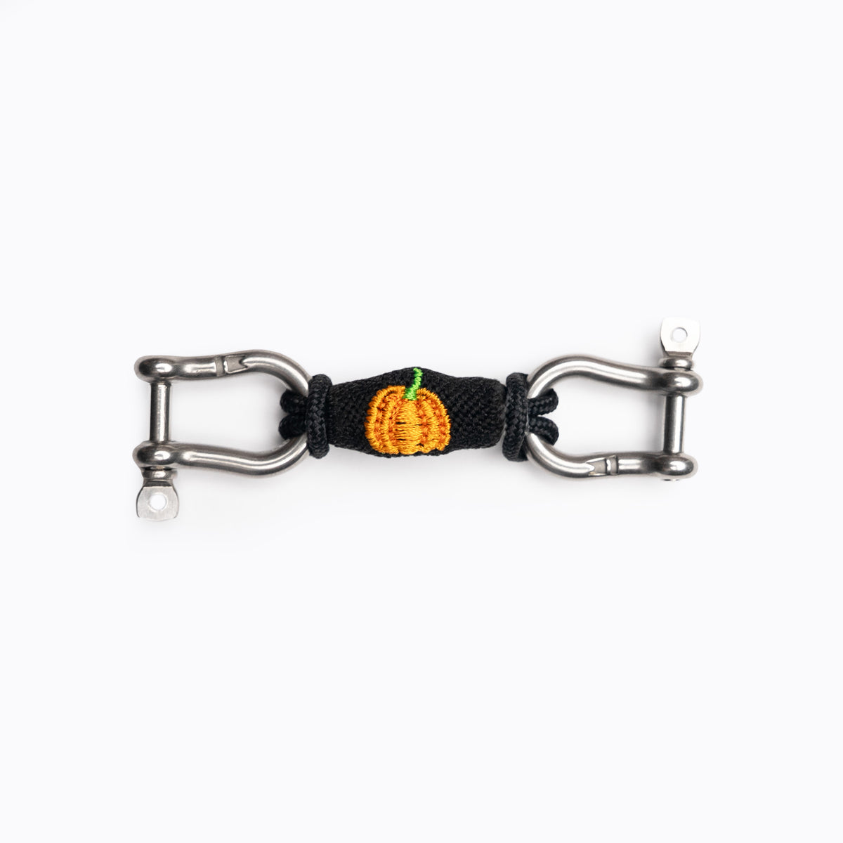 Pumpkin on Black bearing: an orange pumpkin embroidered on black, set between stainless steel shackles